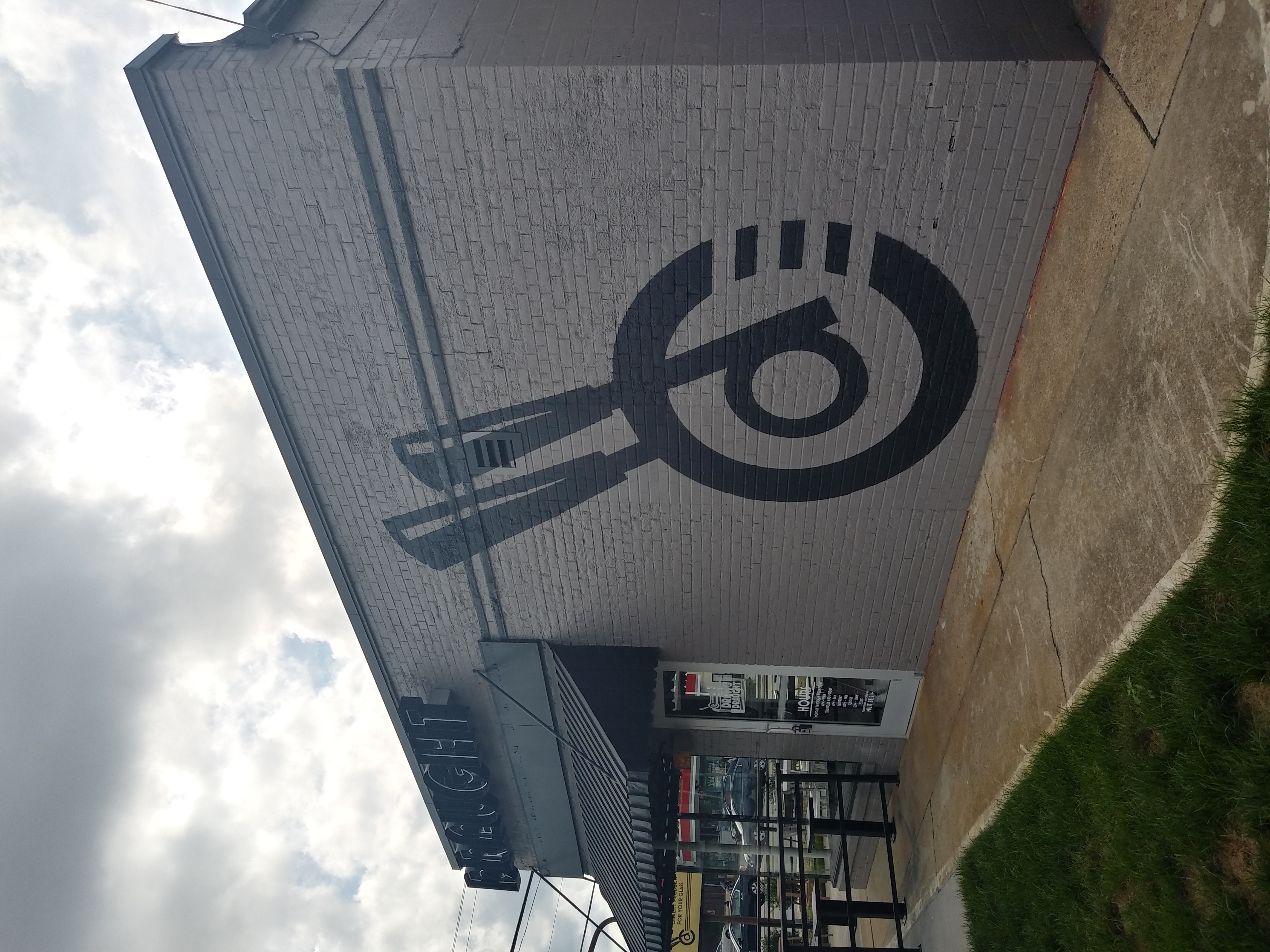 Large exterior building mural — black and white on brick